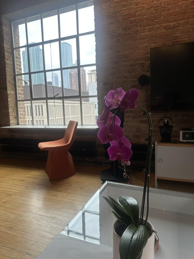 531 S Plymouth Ct Unit 602, Chicago, IL 60605 - living room with hardwood / wood-style flooring, plenty of natural light, and brick wall