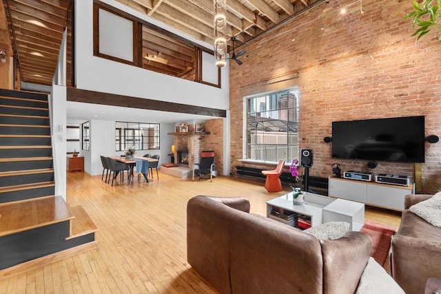 531 S Plymouth Ct Unit 602, Chicago, IL 60605 - living area featuring a towering ceiling, a fireplace, healthy amount of natural light, stairs, and hardwood / wood-style floors