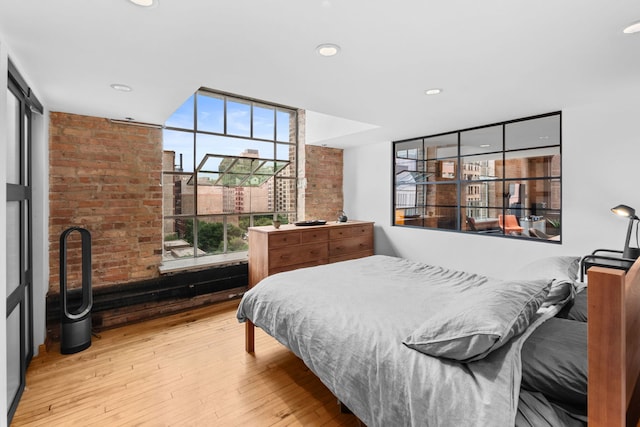 531 S Plymouth Ct Unit 602, Chicago, IL 60605 - bedroom with wood-type flooring, brick wall, and recessed lighting