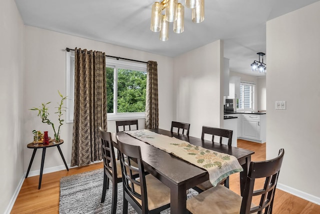 633 Buckthorn Ter, Buffalo Grove, IL 60089 - dining space featuring a chandelier, light wood-style floors, and healthy amount of natural light