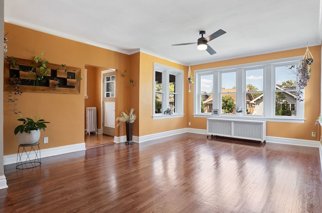 919 N Harvey Ave, Oak Park, IL 60302 - unfurnished living room featuring radiator heating unit, radiator, wood finished floors, ceiling fan, and ornamental molding