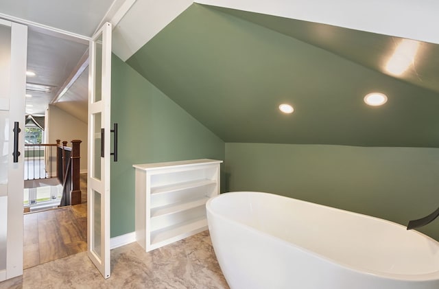 919 N Harvey Ave, Oak Park, IL 60302 - bathroom with a freestanding bath, vaulted ceiling, and recessed lighting