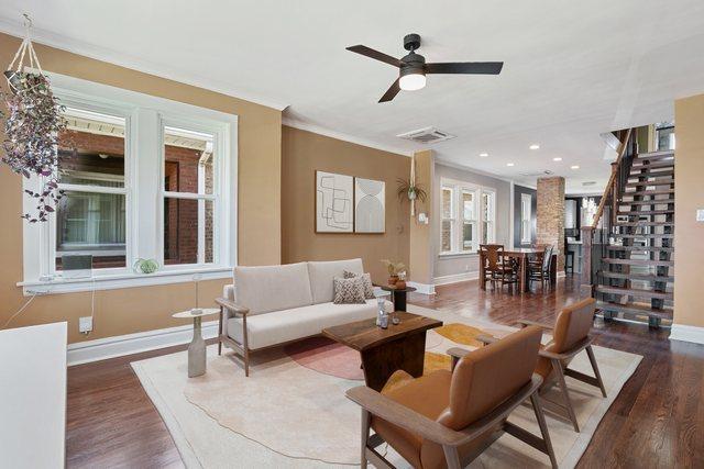 919 N Harvey Ave, Oak Park, IL 60302 - living room featuring crown molding, wood finished floors, stairway, a ceiling fan, and recessed lighting