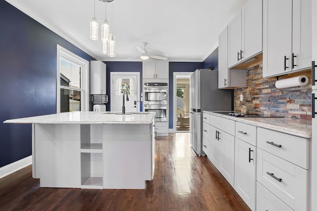 919 N Harvey Ave, Oak Park, IL 60302 - kitchen featuring appliances with stainless steel finishes, tasteful backsplash, ceiling fan, dark wood finished floors, and an island with sink