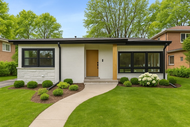 319 Kilpatrick Ave, Wilmette, IL 60091 - view of front of house featuring a front lawn and stone siding
