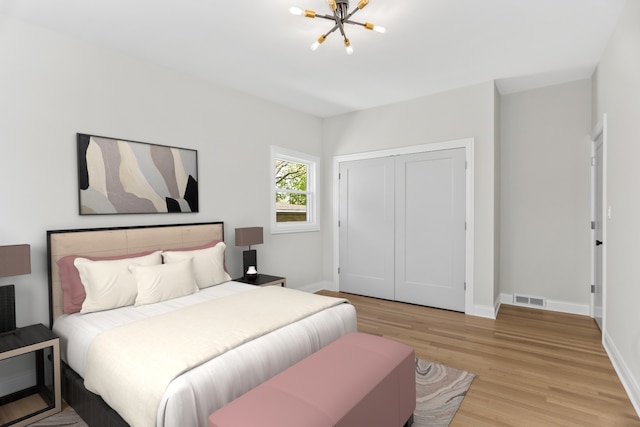 319 Kilpatrick Ave, Wilmette, IL 60091 - bedroom with a chandelier, light wood-type flooring, and a closet