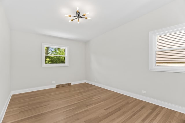 319 Kilpatrick Ave, Wilmette, IL 60091 - spare room featuring a chandelier and light wood-style floors