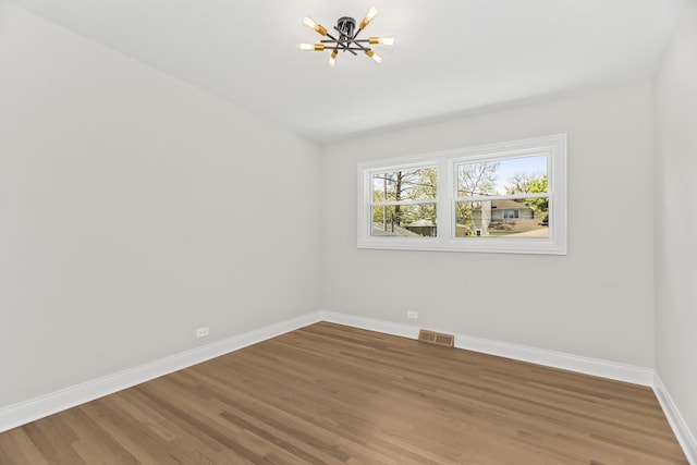 319 Kilpatrick Ave, Wilmette, IL 60091 - unfurnished room featuring a chandelier and light wood-style floors