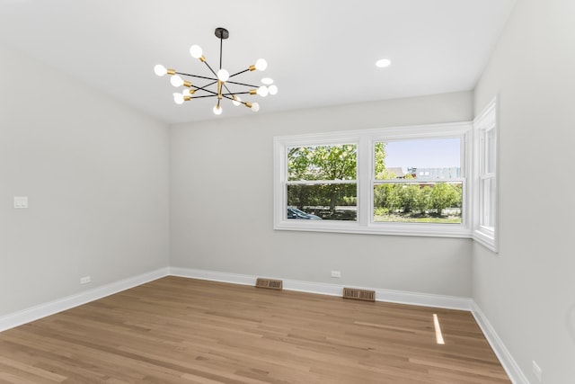 319 Kilpatrick Ave, Wilmette, IL 60091 - unfurnished room with a chandelier and light wood-style floors
