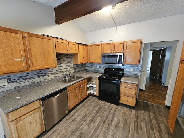 2875 N Vine St, Decatur, IL 62526 - kitchen featuring appliances with stainless steel finishes, decorative backsplash, dark wood-style floors, a textured ceiling, and brown cabinetry