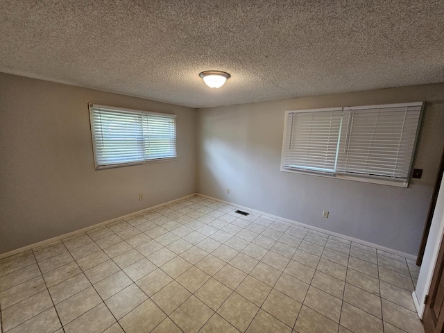 2875 N Vine St, Decatur, IL 62526 - spare room featuring light tile patterned floors and a textured ceiling
