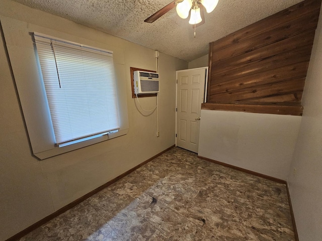 2875 N Vine St, Decatur, IL 62526 - empty room featuring a wall mounted AC, ceiling fan, a textured ceiling, and vaulted ceiling