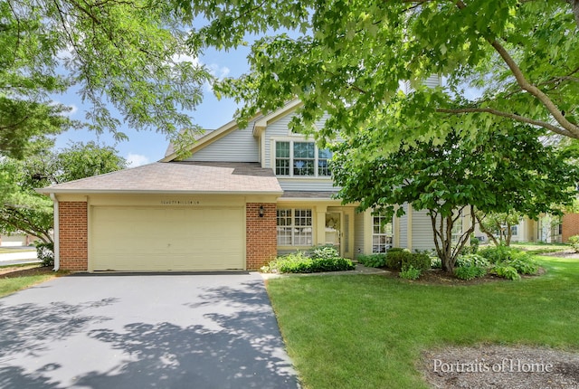 30W075 Willow Ln Unit 0, Warrenville, IL 60555 - view of front facade with driveway, an attached garage, brick siding, and a front lawn