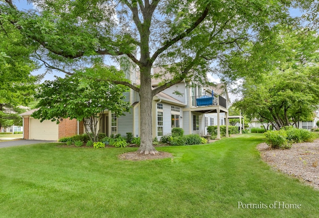 30W075 Willow Ln Unit 0, Warrenville, IL 60555 - view of front of property with a balcony, a front lawn, driveway, an attached garage, and brick siding