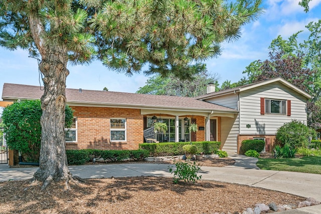 330 N Country Club Dr, Addison, IL 60101 - split level home with brick siding and a chimney