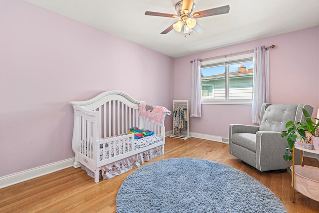 330 N Country Club Dr, Addison, IL 60101 - bedroom with wood finished floors, a crib, and a ceiling fan