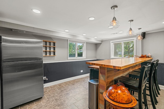 330 N Country Club Dr, Addison, IL 60101 - kitchen with freestanding refrigerator, wooden counters, ornamental molding, plenty of natural light, and recessed lighting