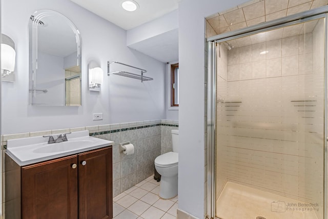 330 N Country Club Dr, Addison, IL 60101 - bathroom with tile patterned flooring, vanity, a shower stall, tile walls, and a wainscoted wall