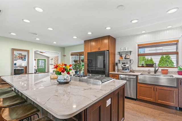 330 N Country Club Dr, Addison, IL 60101 - kitchen with stainless steel appliances, plenty of natural light, a breakfast bar, light wood-style flooring, and recessed lighting