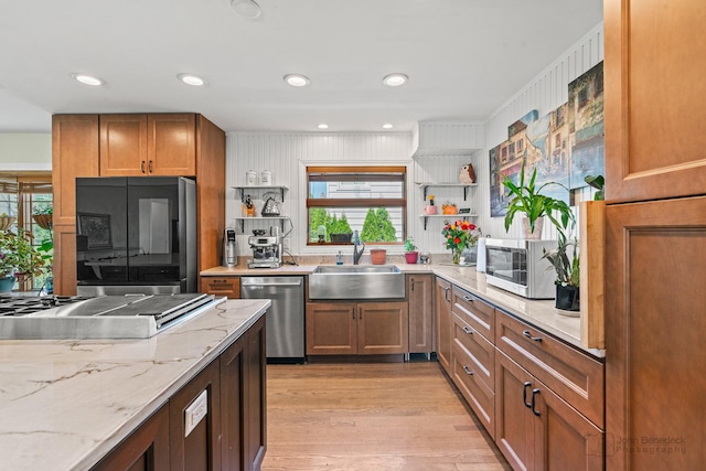 330 N Country Club Dr, Addison, IL 60101 - kitchen with appliances with stainless steel finishes, open shelves, light wood-type flooring, light stone counters, and brown cabinets