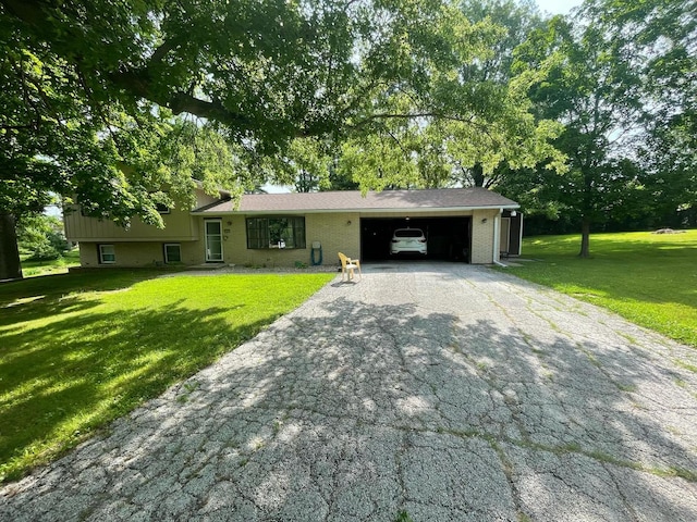 112 Crestview Dr, Hamilton, IL 62341 - split level home with driveway, an attached garage, a front lawn, and brick siding