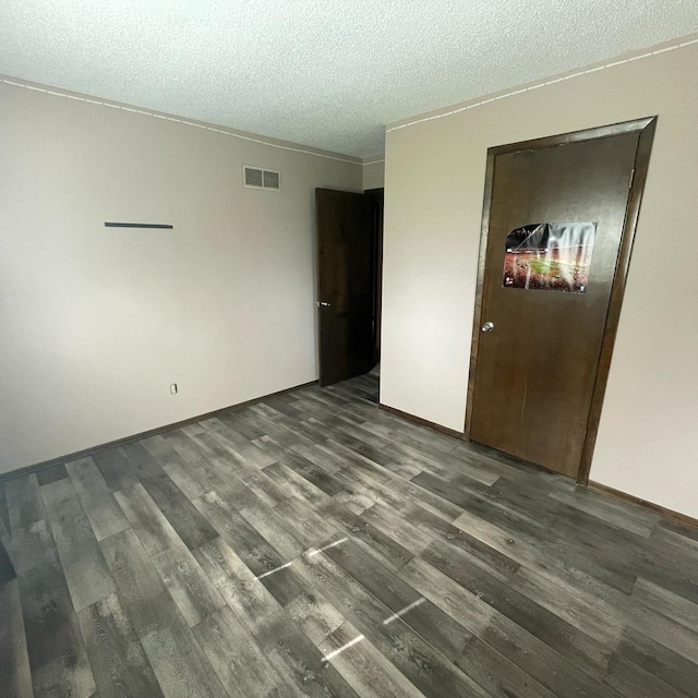 112 Crestview Dr, Hamilton, IL 62341 - empty room featuring dark wood-style flooring and a textured ceiling