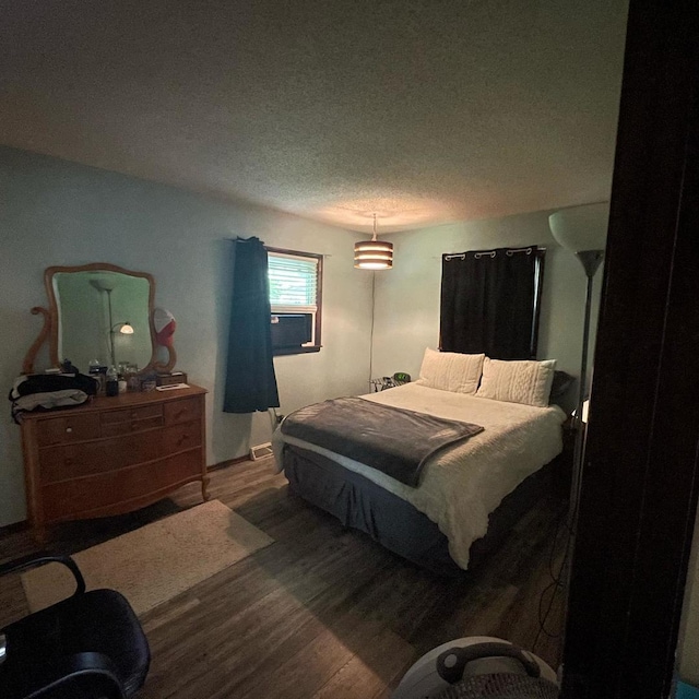 112 Crestview Dr, Hamilton, IL 62341 - bedroom featuring wood finished floors, a textured ceiling, and cooling unit