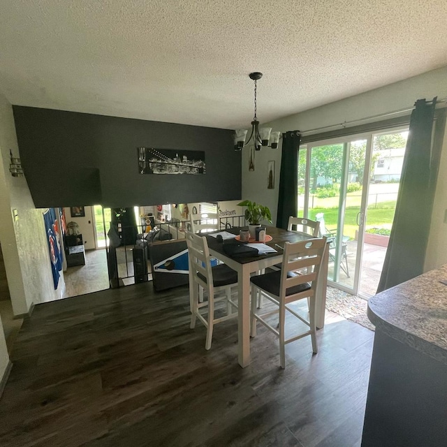 112 Crestview Dr, Hamilton, IL 62341 - dining space with a chandelier, wood finished floors, and a textured ceiling