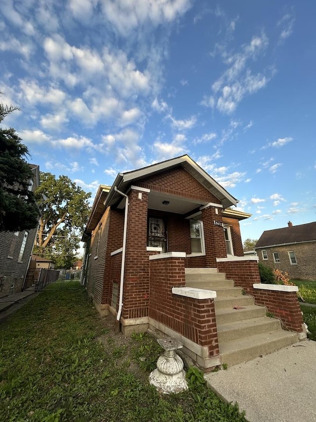 8427 S Peoria St, Chicago, IL 60620 - view of front facade featuring brick siding and a porch