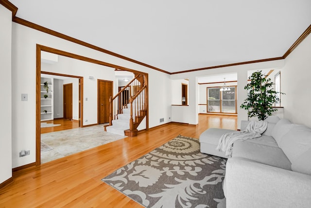 1630 Ainsley Ln, Lombard, IL 60148 - living area featuring stairs, light wood-type flooring, crown molding, and a chandelier