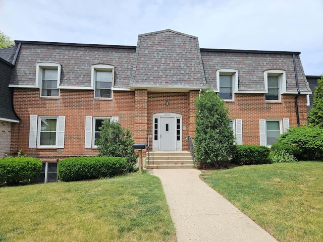 855 Village Quarter Rd Unit C, West Dundee, IL 60118 - view of front of house with brick siding, a front lawn, and mansard roof