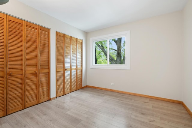 4825 W 109th St Unit 303, Oak Lawn, IL 60453 - unfurnished bedroom with multiple closets and light wood-type flooring