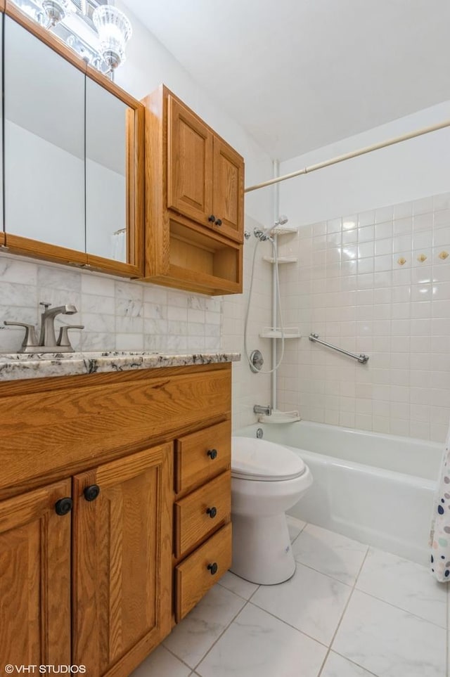 7033 N Kedzie Ave Unit 512, Chicago, IL 60645 - full bath with vanity, shower / washtub combination, marble finish flooring, and decorative backsplash