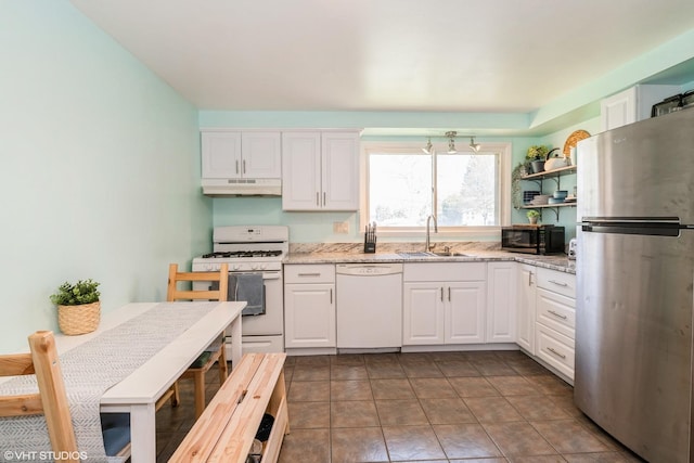 31 Medinah Ave, Fox Lake, IL 60020 - kitchen with white appliances, under cabinet range hood, white cabinetry, and light stone countertops
