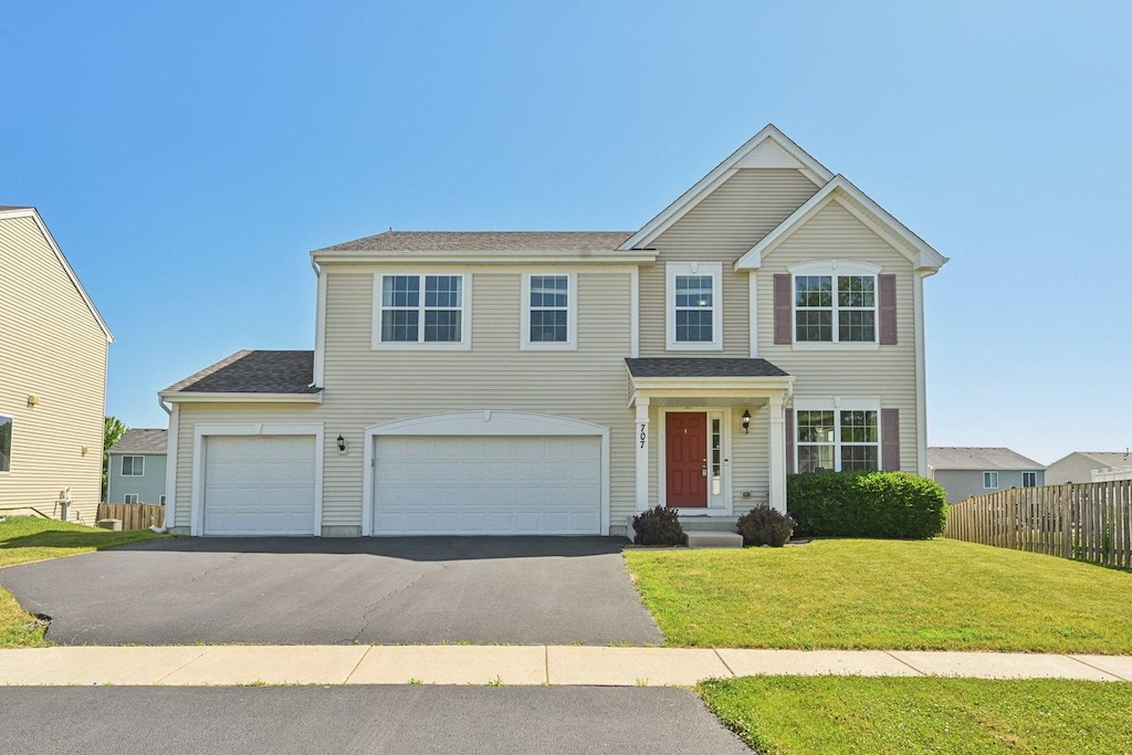 707 Brighton Dr, Pingree Grove, IL 60140 - traditional home with asphalt driveway and an attached garage