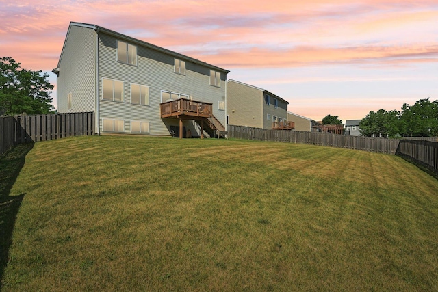 707 Brighton Dr, Pingree Grove, IL 60140 - back of property at dusk featuring a fenced backyard, a deck, and stairway