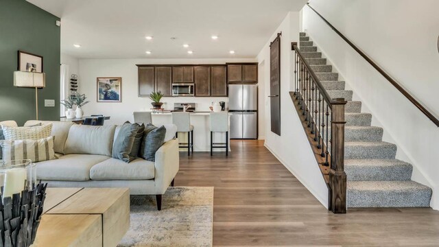 5025 Yates Dr, Mount Pleasant, WI 53403 - living area with stairway, wood finished floors, and recessed lighting