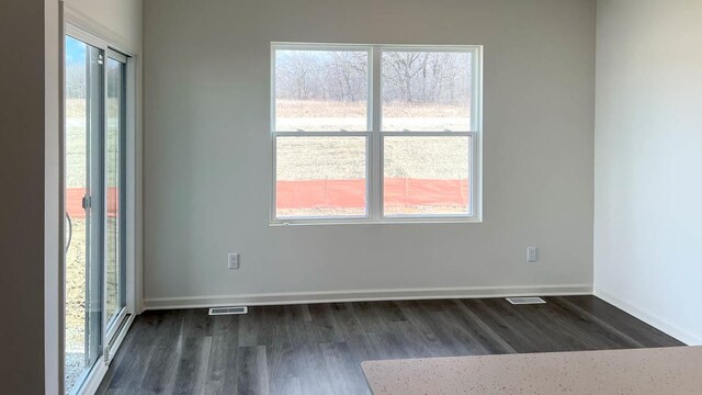 5025 Yates Dr, Mount Pleasant, WI 53403 - unfurnished room with dark wood finished floors and plenty of natural light