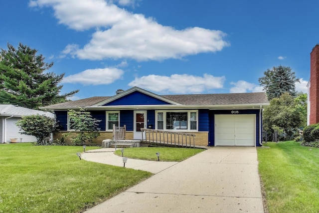 915 Carol Ave, Elgin, IL 60123 - single story home featuring an attached garage, driveway, a front lawn, a porch, and roof with shingles