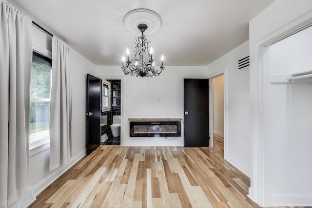 915 Carol Ave, Elgin, IL 60123 - unfurnished dining area with a chandelier, light wood-type flooring, and heating unit