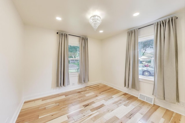 915 Carol Ave, Elgin, IL 60123 - unfurnished room featuring light wood finished floors, recessed lighting, and a chandelier