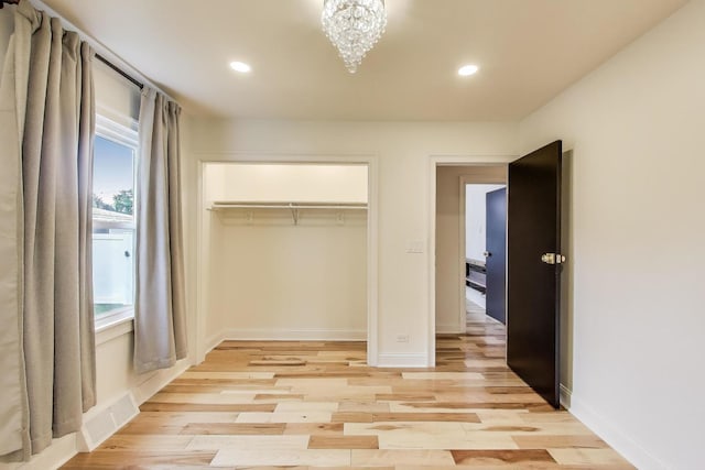 915 Carol Ave, Elgin, IL 60123 - unfurnished bedroom with recessed lighting, light wood-type flooring, a closet, and a chandelier