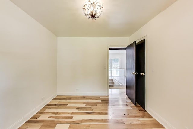 915 Carol Ave, Elgin, IL 60123 - unfurnished room with light wood finished floors and a chandelier