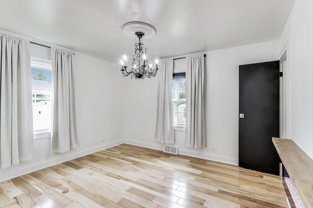 915 Carol Ave, Elgin, IL 60123 - unfurnished dining area featuring a chandelier and light wood-style flooring