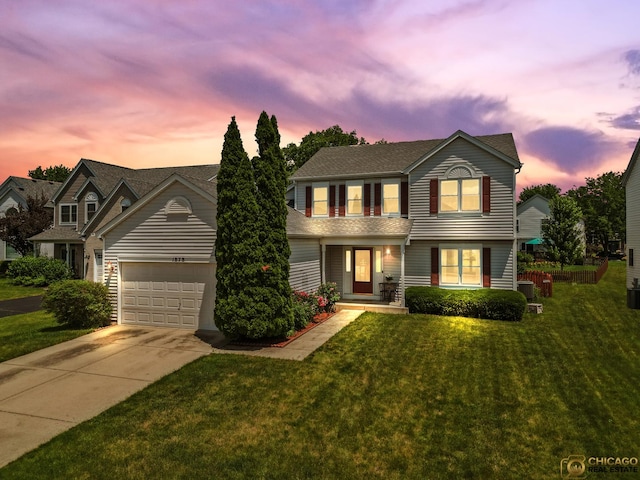 1878 Grassy Knoll Ct, Romeoville, IL 60446 - traditional-style home featuring driveway, an attached garage, a yard, covered porch, and roof with shingles