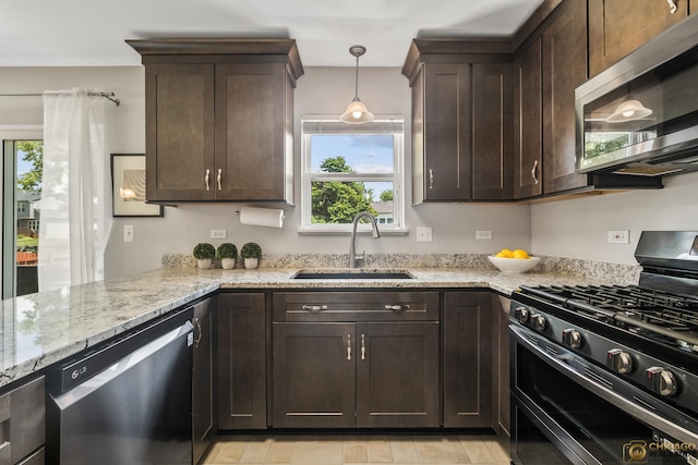 1878 Grassy Knoll Ct, Romeoville, IL 60446 - kitchen featuring appliances with stainless steel finishes, plenty of natural light, dark brown cabinetry, and light stone counters