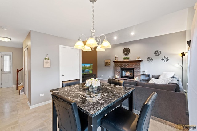 1878 Grassy Knoll Ct, Romeoville, IL 60446 - dining space with a chandelier, a brick fireplace, and recessed lighting
