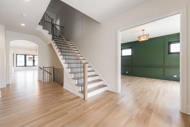 425 Sherman St, Downers Grove, IL 60515 - stairway featuring wood finished floors, arched walkways, a chandelier, and recessed lighting
