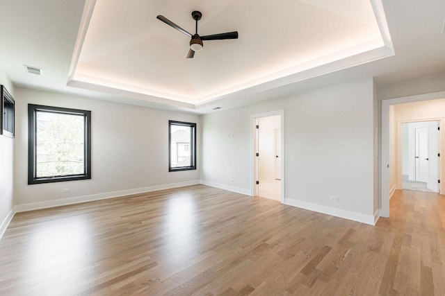 425 Sherman St, Downers Grove, IL 60515 - empty room with a tray ceiling, a ceiling fan, and light wood-style floors