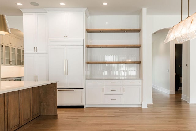 425 Sherman St, Downers Grove, IL 60515 - kitchen with paneled built in fridge, arched walkways, light wood-type flooring, white cabinets, and open shelves